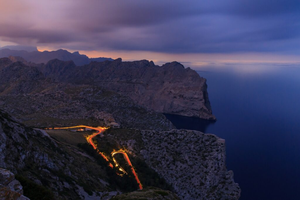 long exposure road at night between mountains