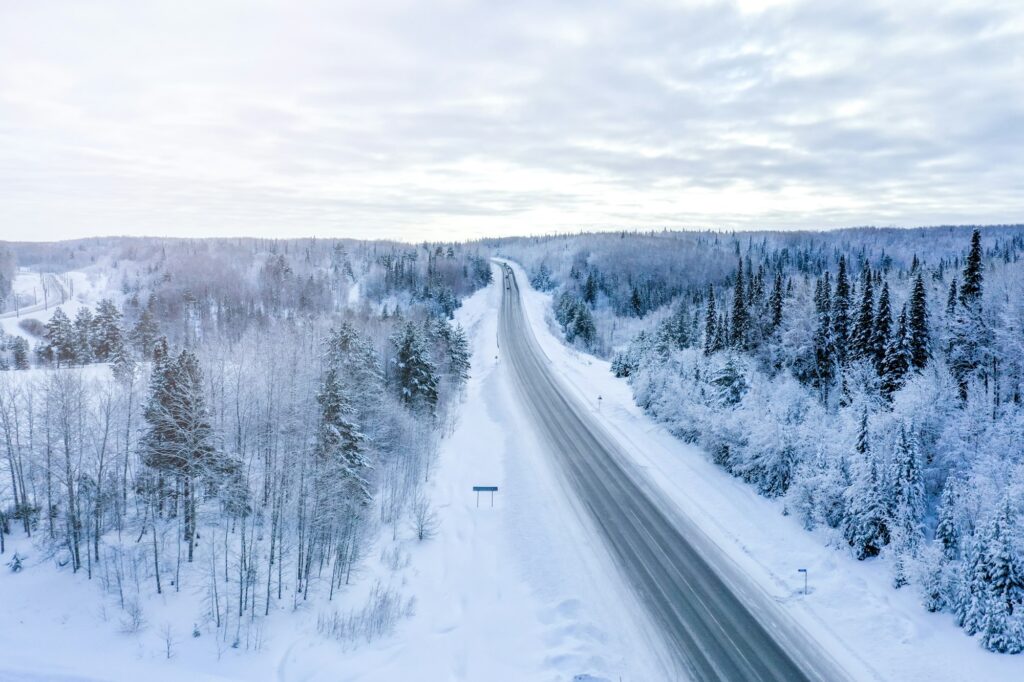 Road in the winter forest top view. aerial photography from a drone