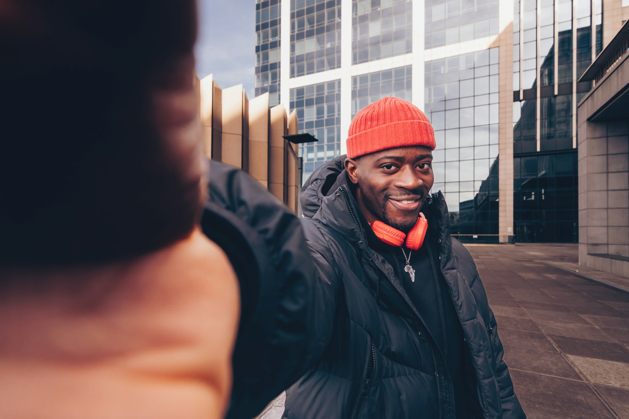 smiling african american young man influencer in street hip hip style