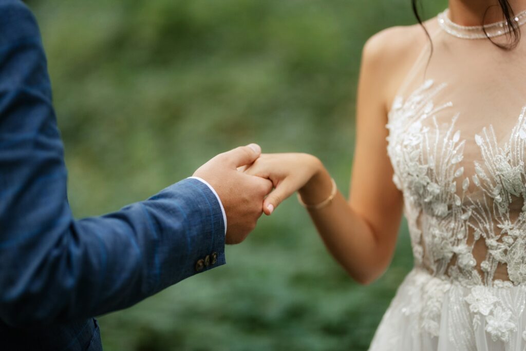 wedding walk of the bride and groom in the deciduous forest in summer